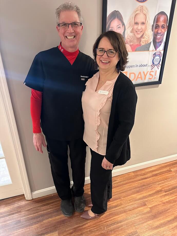 Dentist and team member smiling in the office, representing general dentistry care in Lunenburg